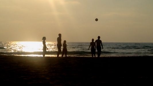 Playing Football on the Beach