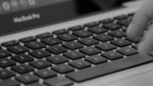 Typing on a Macbook Laptop