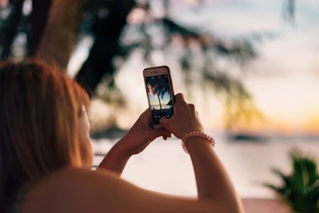 Woman Taking Photo on Beach