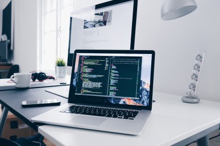 Code on a MacBook Laptop in Minimal Office