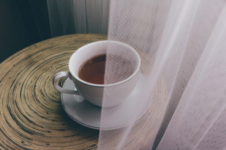 Cup of Tea & Saucer on Round Wooden Table