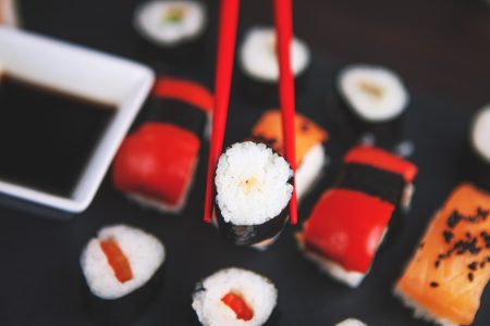 Sushi Held in Chopsticks