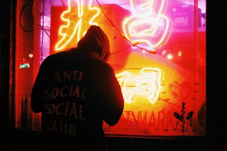 Man by Neon Sign