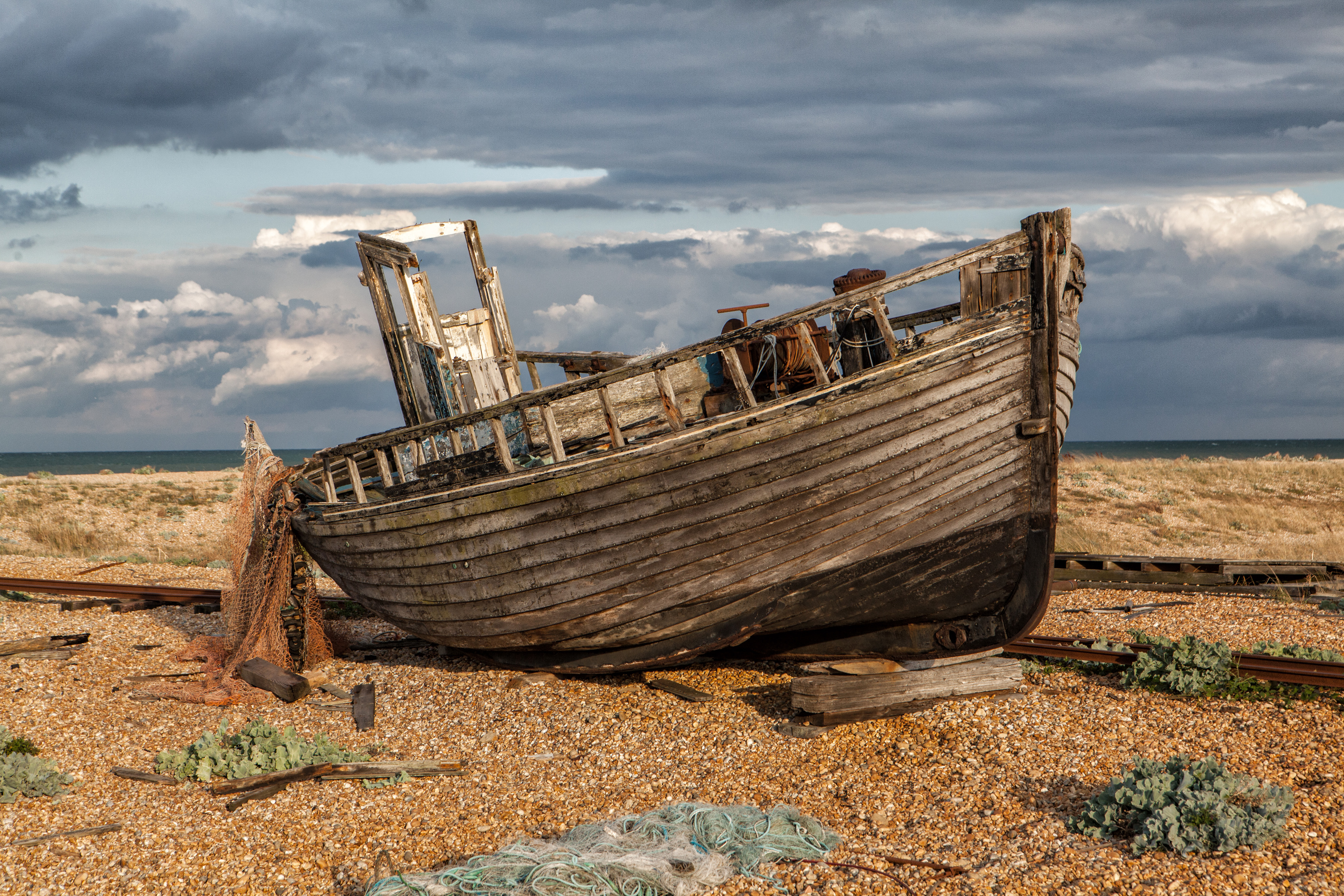 Old Fishing Boat on shore with Storm moving in Photograph by