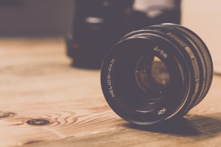 Camera Lens on Wooden Table