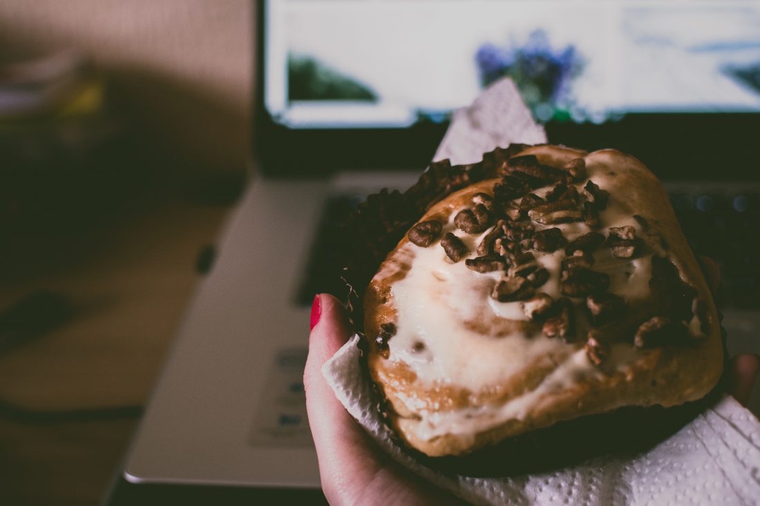 Free stock image of Eating Muffin on Laptop