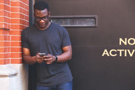 Man Typing on Mobile Phone