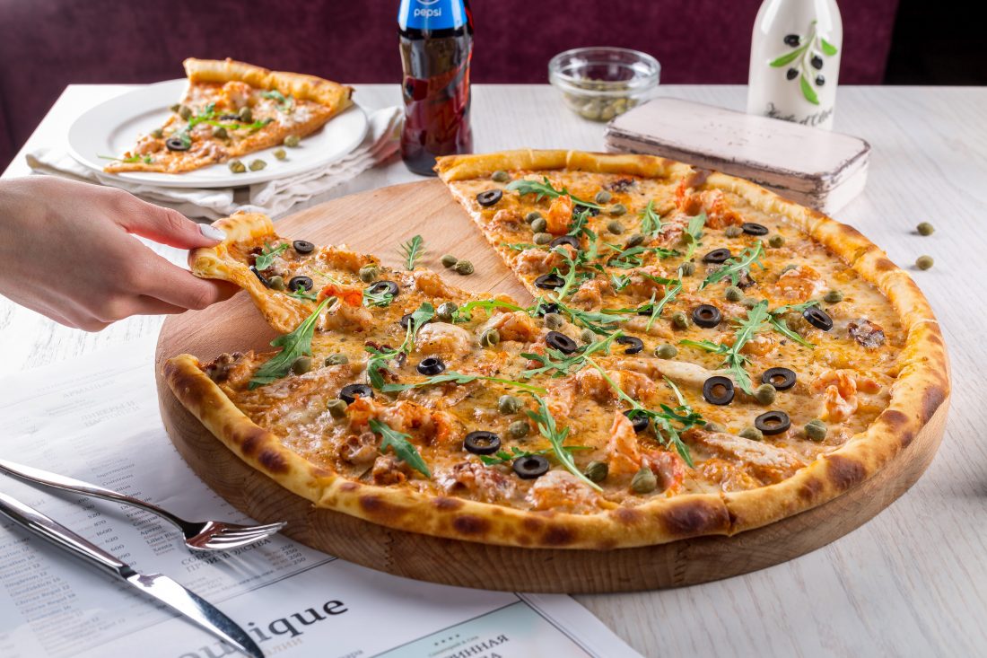 Free stock image of Hand Grabbling Pizza Slice