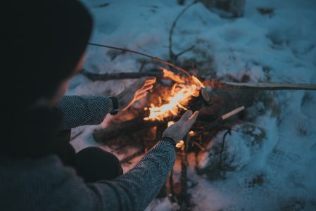 Woman Warming at Camp Fire