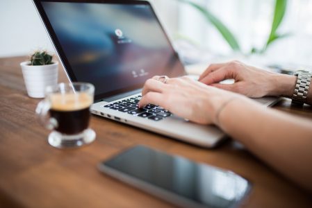 Woman Typing on Computer Desk