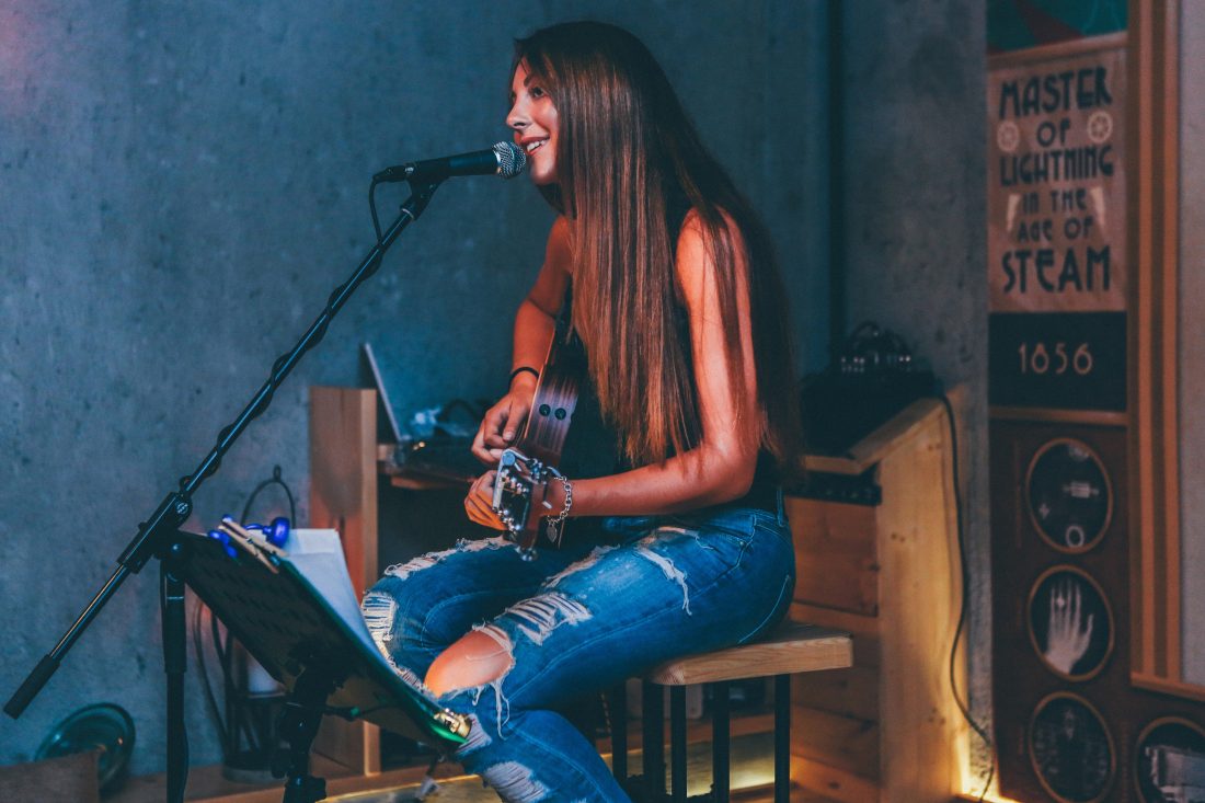 Free stock image of Woman Singing Microphone Guitar Amp