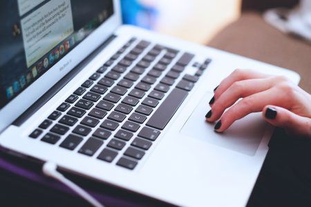 Woman Using Laptop Online