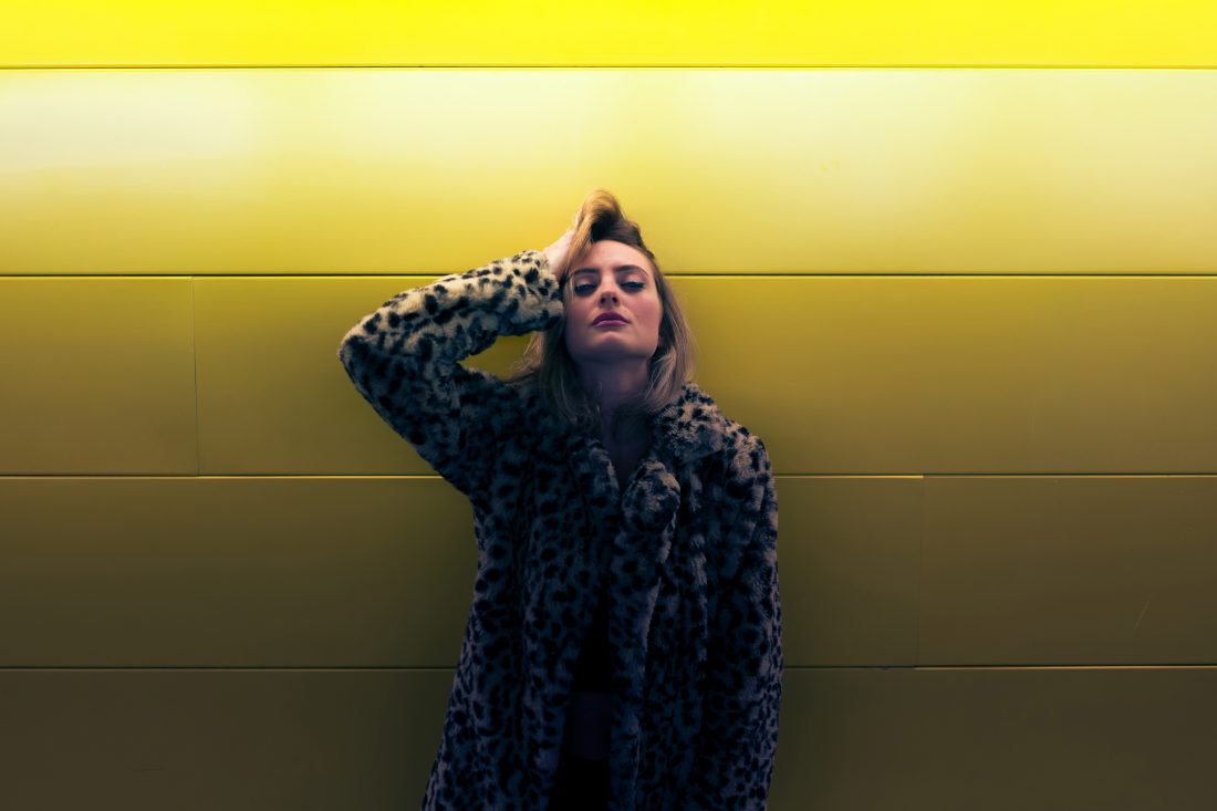 Free stock image of Woman By Yellow Wall