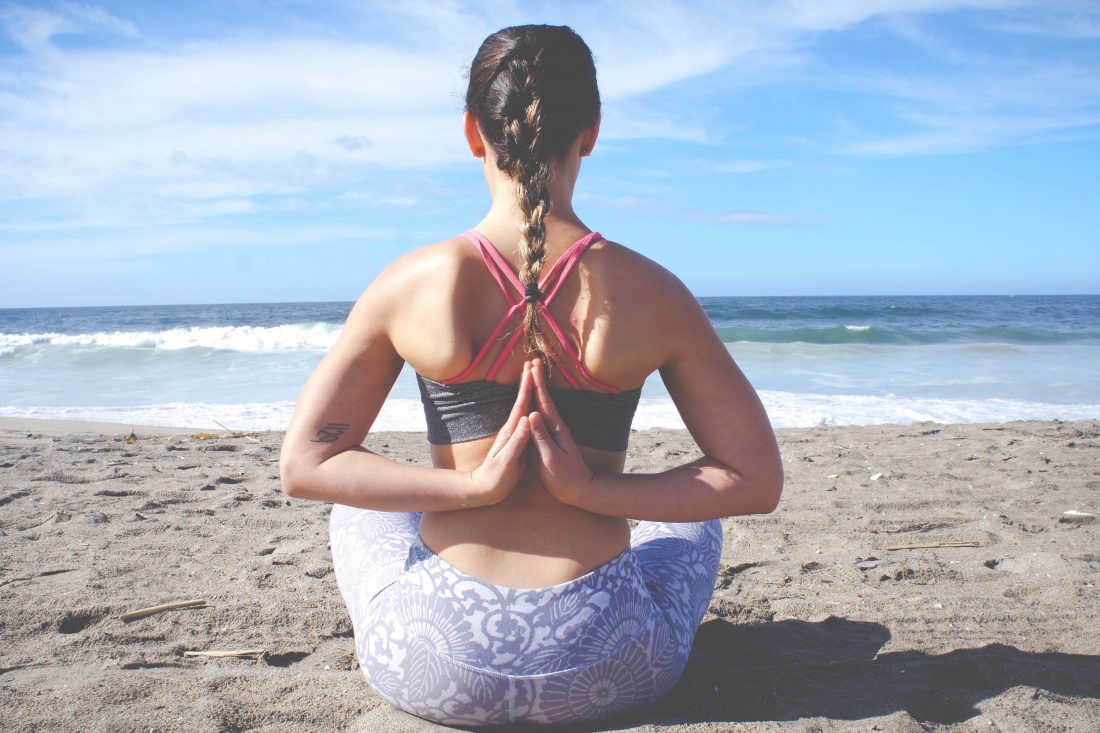 Woman in bikini practice yoga Eka Pada Rajakapotasana Royal pigeon Pose at  seaside, close-up view Stock Photo by ©familylifestyle 185002698