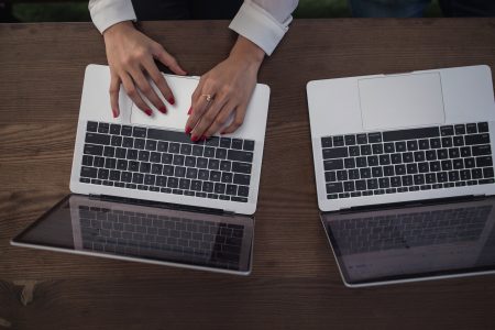 Hands Typing on Laptop