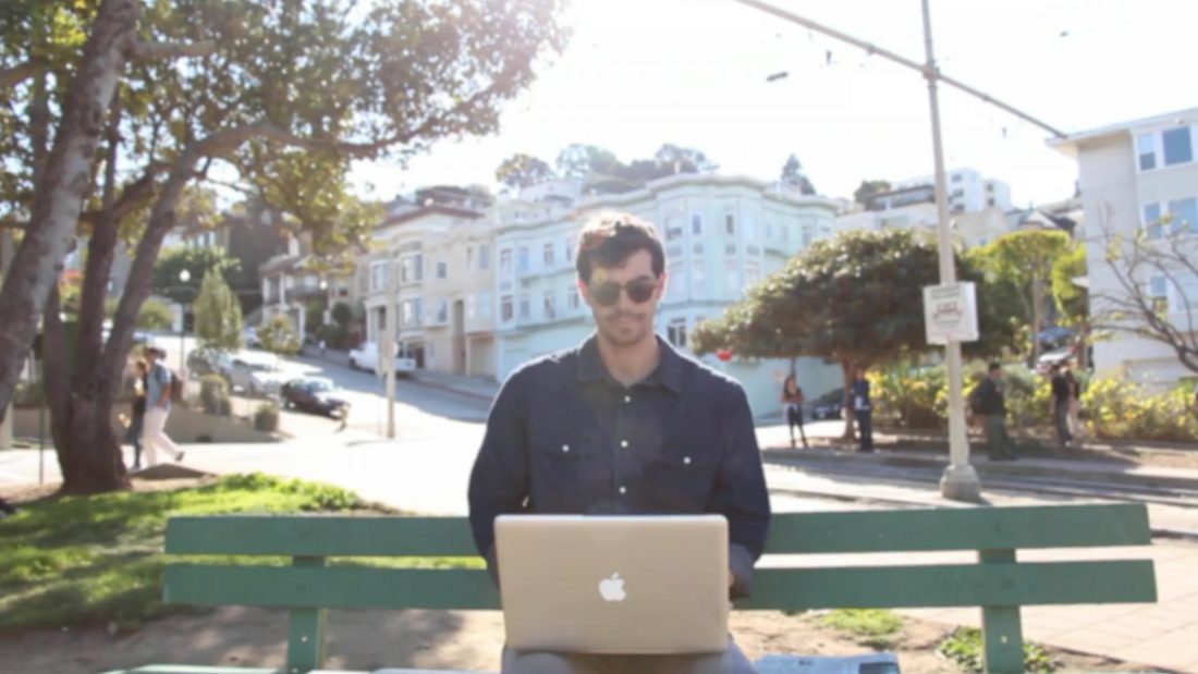 Man Reading Newspaper on Bench