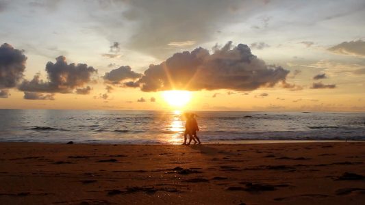 Couple Walking At The Beach