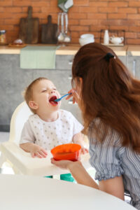 Mother Feeding Child